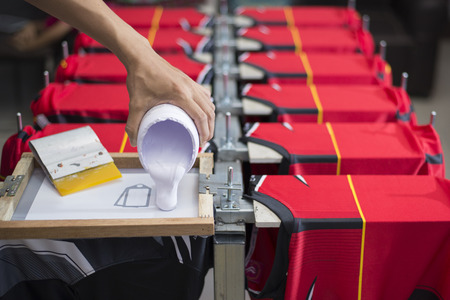 Handmade screen printing t-shirt is an important step of craftsmen, Close-upの写真素材