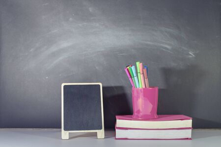 Educational background concept, Stationery and Mimi Blackboard placed on table in classroom.の写真素材