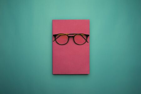 Glasses, book and stationery placed on blue background, Back to school concept, Copy-spaceの写真素材