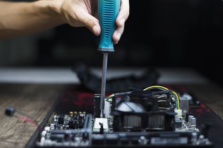 Changing devices to increase computer performance, Expert fixing the computer motherboard, Close-upの写真素材