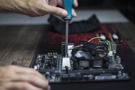 Changing devices to increase computer performance, Expert fixing the computer motherboard, Close-upの写真素材