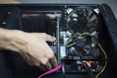 Computer repair and maintenance, Technician is fixing computer at night, Close-upの写真素材