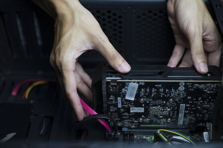 Computer repair and maintenance, Technician is fixing computer at night, Close-upの写真素材