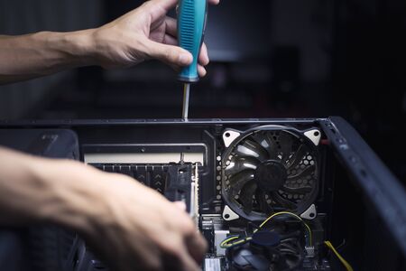 Computer repair and maintenance, Technician is fixing computer at night, Close-upの写真素材