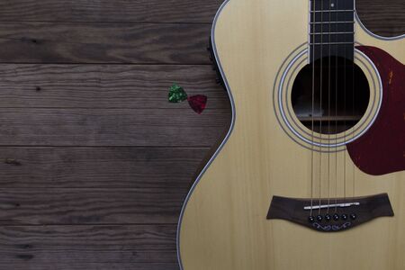 Acoustic guitar on an old wooden table, See only the acoustic guitar body, Close-up, Copy-space.の写真素材