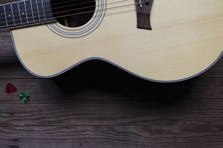 Acoustic guitar on an old wooden table, See only the acoustic guitar body, Close-up, Copy-space.の写真素材