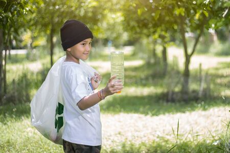 Children look at the plastic bottle collected in park, Copy-spaceの写真素材
