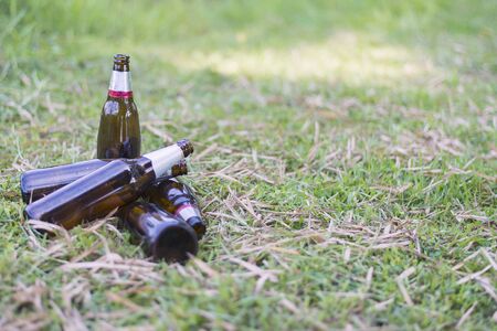 Glass bottles piled on the lawn, Focus on bottle, Environmental concept. Close-up.の写真素材