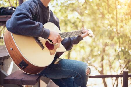 Natural guitarist, People playing acoustic guitar in the garden, Close-upの写真素材