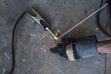 Welder is welding the screw, And cause sparks, Close-up.の写真素材