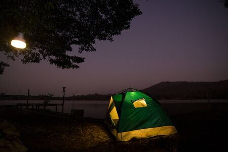 Camping by the river, Night photography, Picture has noise.の写真素材