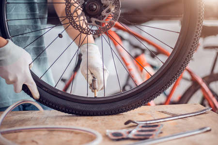 Bicycle Tire Care, Cyclist are fixing bicycle wheels, Close-up.の写真素材