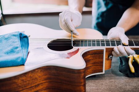 Modify acoustic guitar, Guitar repairman is working, Close-up.の写真素材