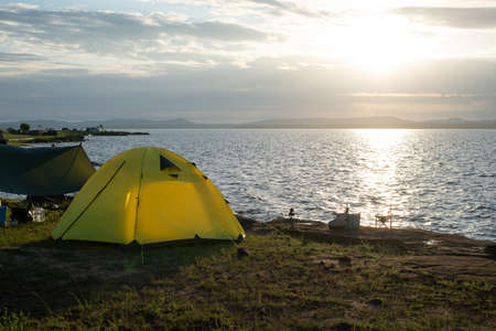 Camping by the sea, Tent on coast at sunrise.の写真素材