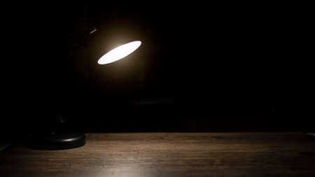 Lamp on desk at night, Free space for text.の写真素材