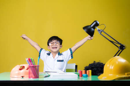Happy boy doing homework, Learning equipment on the table.の写真素材