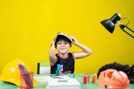 Children doing homework, Look at the camera, At the desk.の写真素材