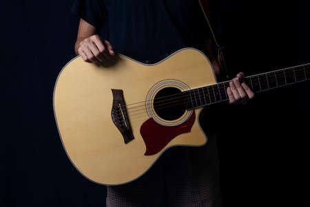 Musician at night, Player with an acoustic guitar in the dark, With side lighting.の写真素材
