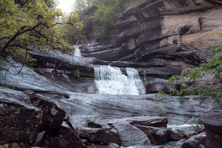 Tropical waterfall, waterfall in the rainy season flows through the mountains.の写真素材