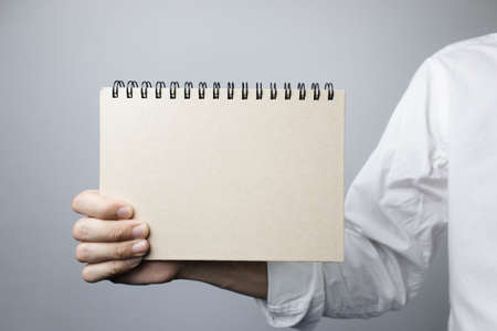 Person holding a horizontal notebook, Copy space for text.の写真素材