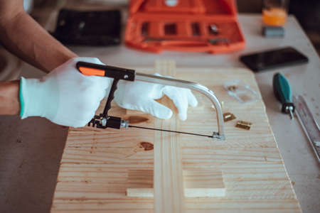 DIY woodworking, Carpenter saw wood, Close up.の写真素材