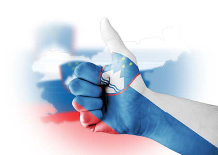 Thumb up with digitally body-painted Slovenia flagの写真素材