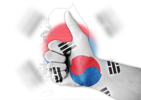 Thumb up with digitally body-painted South Korea flagの写真素材