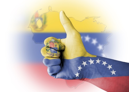 Thumb up with digitally body-painted Venezuela flagの写真素材