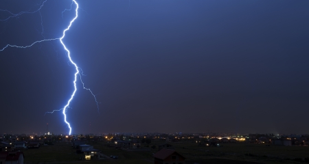 Lightning over small townの写真素材