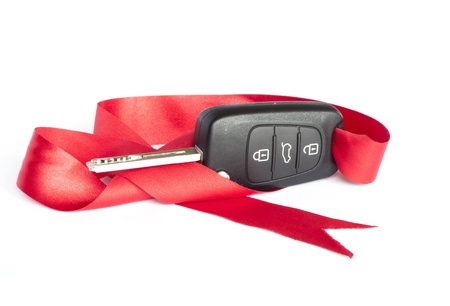 Gift key concept with red Bow on a white background の写真素材