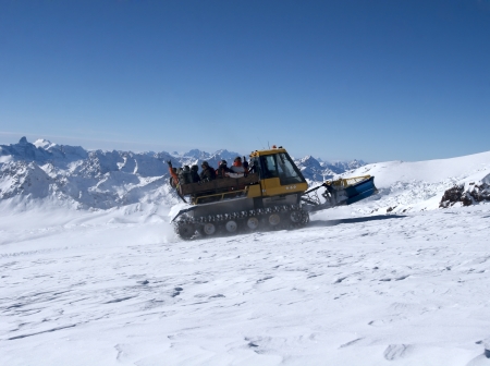 Snowcat with people going up the hill. The beautiful landscape of the Caucasus Mountains at Elbrusの写真素材