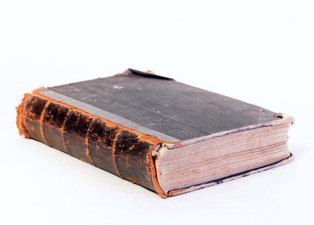 Thick old book on the background. In the closed position