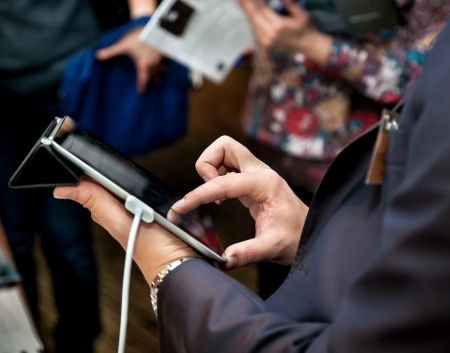 Businessman holding a touchpad pc, one finger touches the screenの写真素材