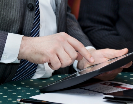 Businessman holding a touchpad pc and touches the screenの写真素材