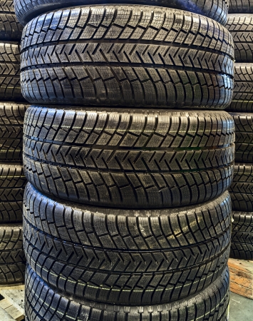 Stack of car tires on warehouse closeupの写真素材