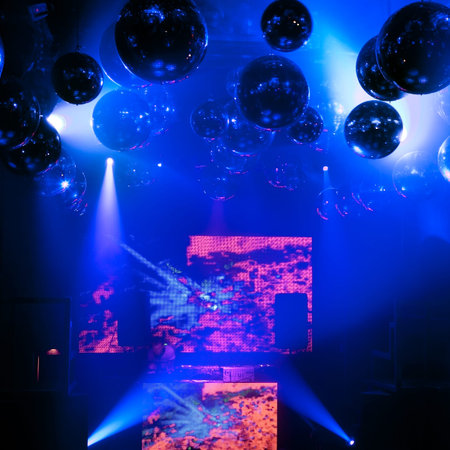 DJ mixes at a nightclub on the scene for a game  Bright beautiful lighting