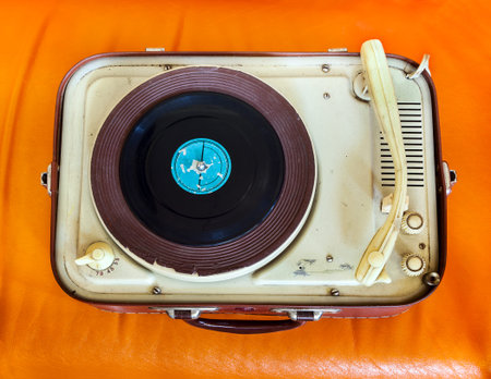 Retro portable turntable on orange backgroundの写真素材