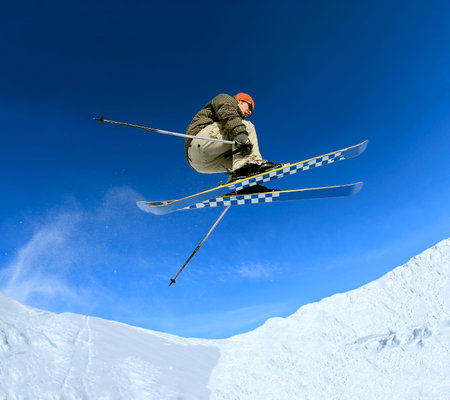 Jumping skier on blue sky 