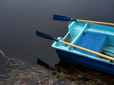 Rear of the boat on the water near the shoreの写真素材