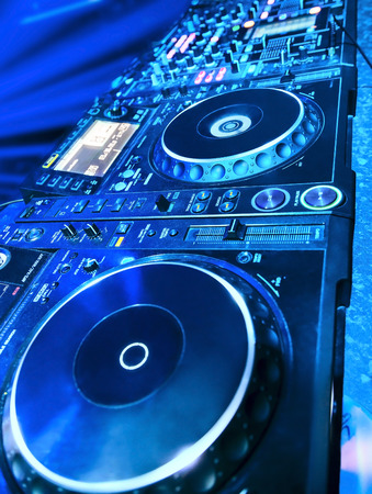 DJ CD player and mixer in nightclubの写真素材