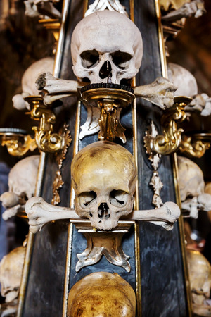 Human skull in the basement vault, lined one over the other. Symbol pirate flagの写真素材