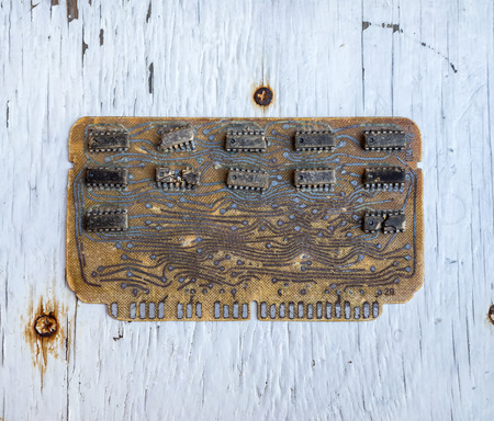 Old controller computer circuit board from a mainframe computer manufactured. Strong and evident defect chips on background of the old painted surfaceの写真素材