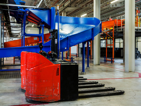 Sorting line for cargo in large modern warehouse with forkliftsのeditorial素材