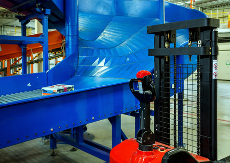 Sorting line for cargo in large modern warehouse with forkliftsのeditorial素材