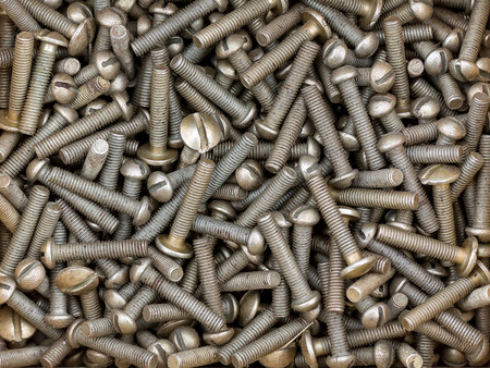 Pile of a metal fixing bolts with thread on backgroundの写真素材