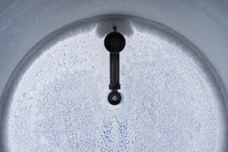 Frosty pattern on window porthole in the winterの写真素材