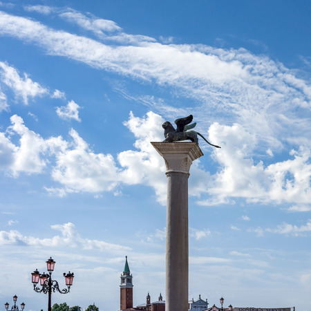 VENICE, ITALY - JULY 2,2014: Silhouette of east column of St. Mark (bronze statue of winged lion) on Piazza San Marco in Venice, Italyのeditorial素材