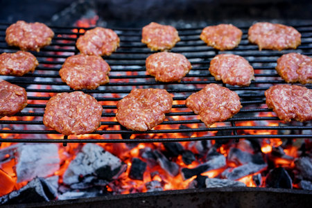 Grilled burgers on a barbecue grill close-upの写真素材