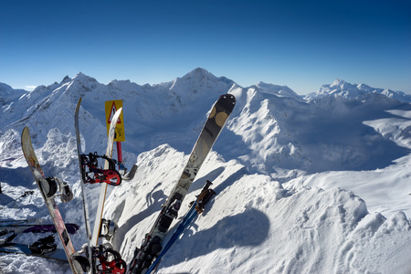 Skis and snowboards equipment standing upright in snowの写真素材