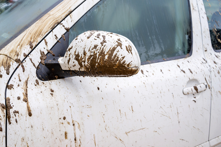 Fragment of dirty car in rural areas close-upの写真素材